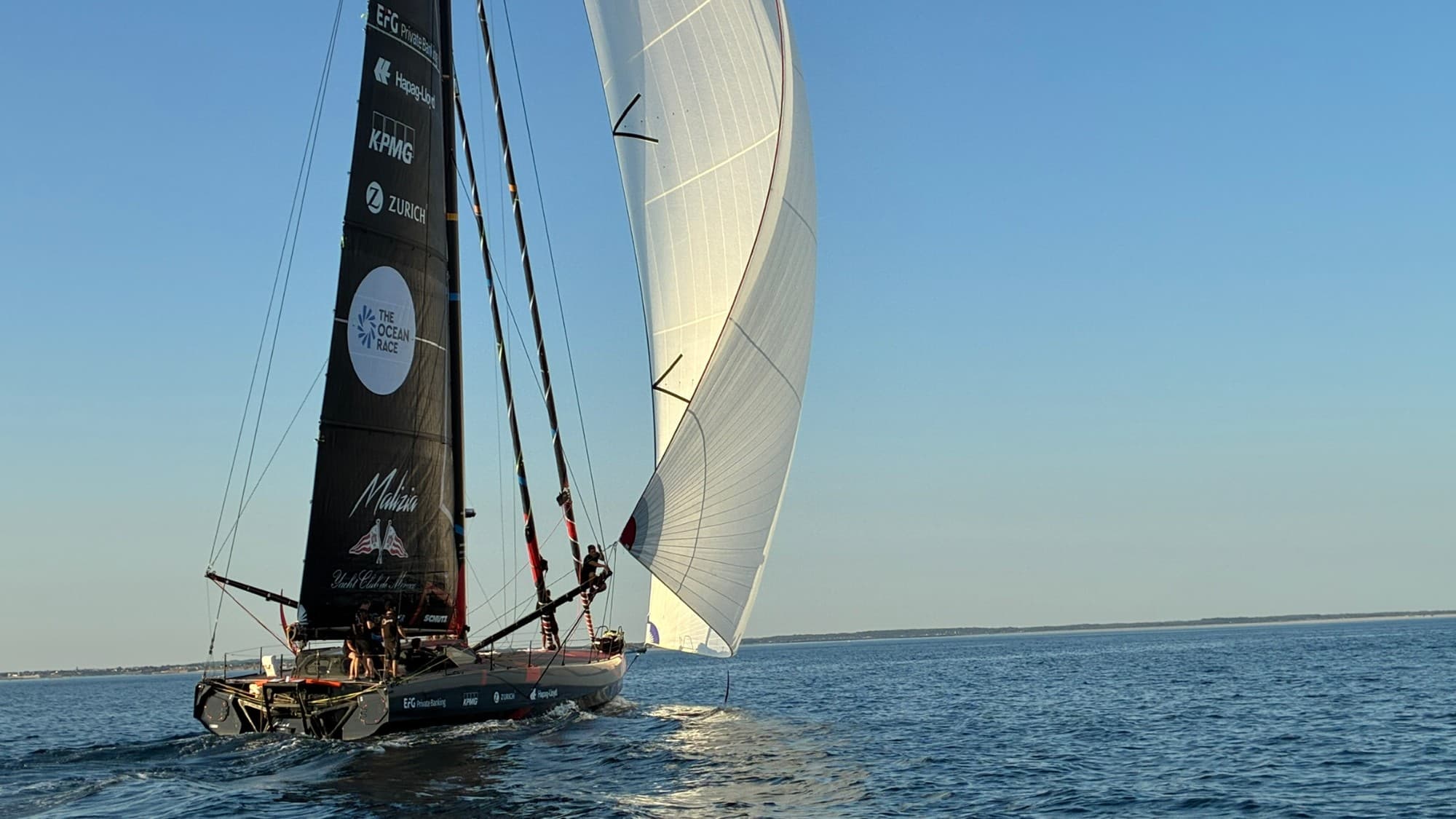 Team Malizia IMOCA sailing under a large white headsail